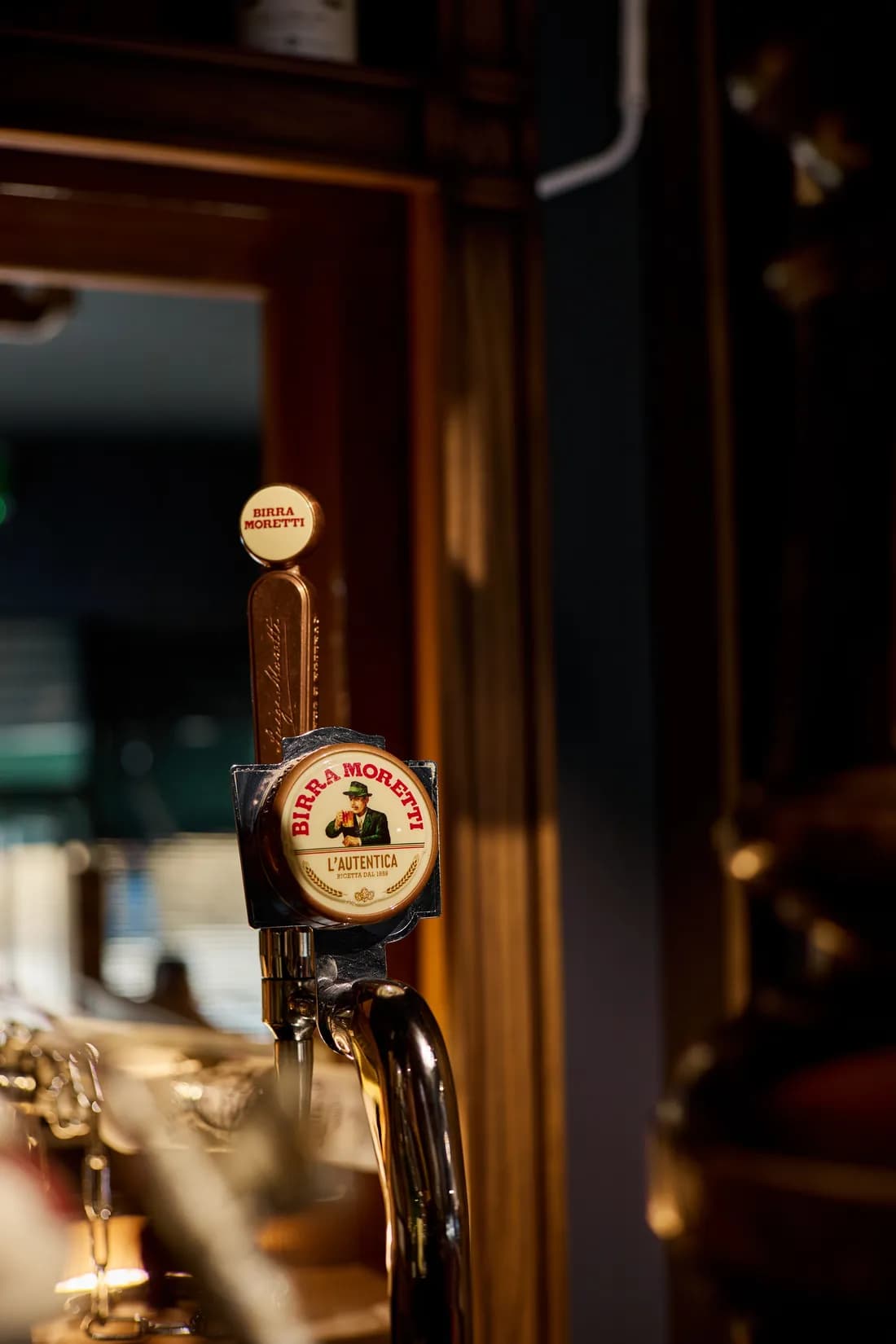 Brass beer taps on the counter at the back of the shop