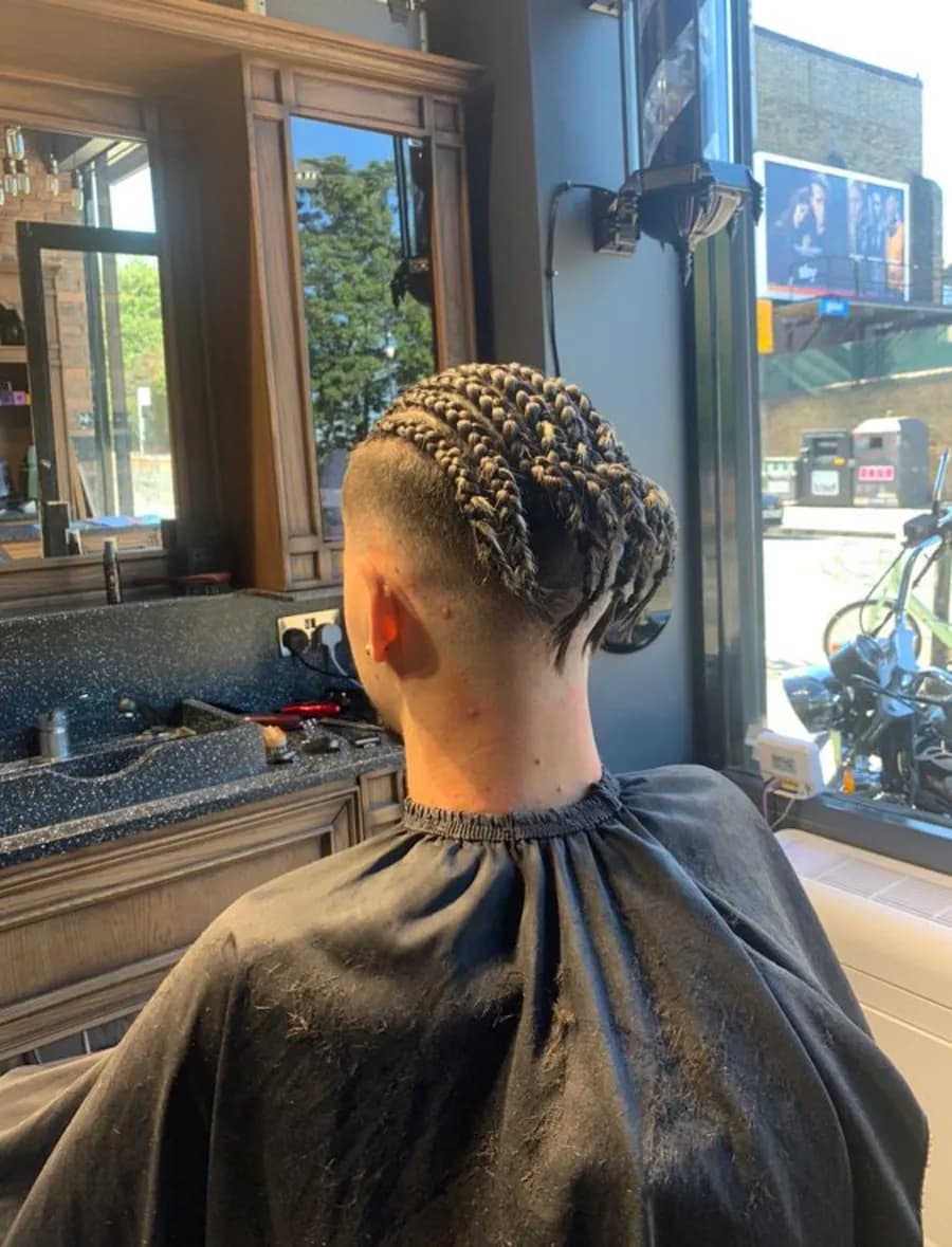 Braided hair on top with the sides faded