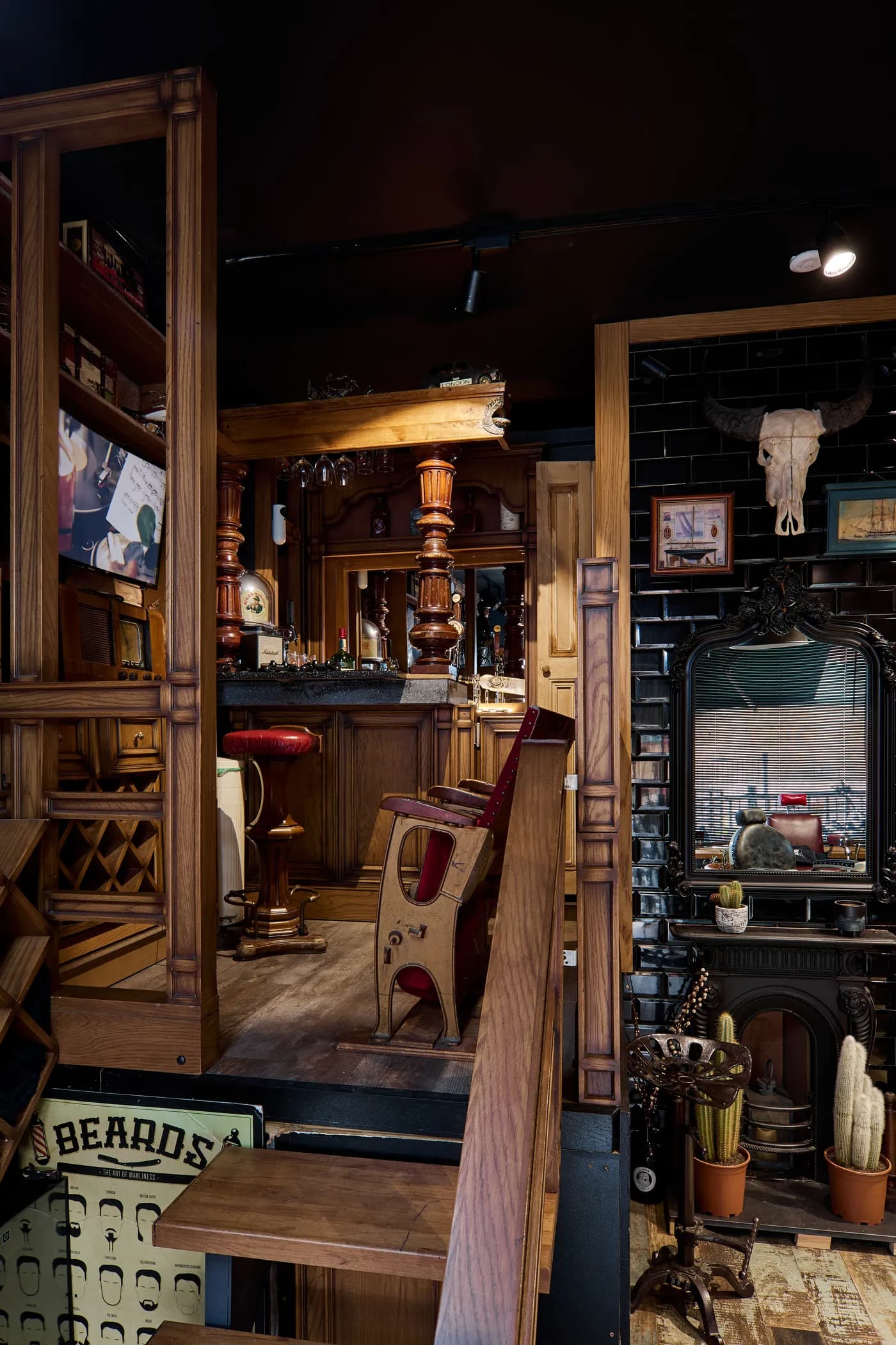 The far end of the shop: cabinets, a mirror, a fireplace and a second chair